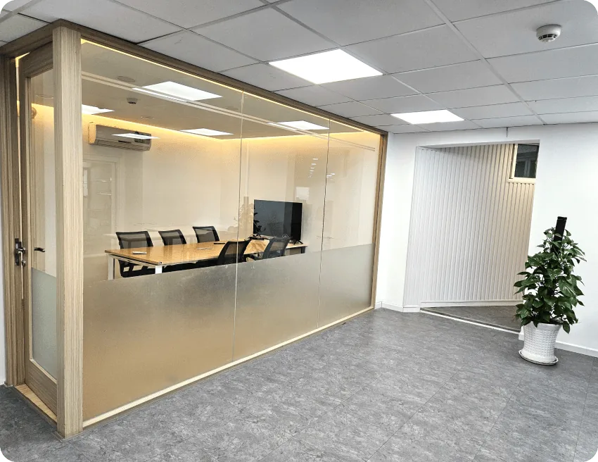 Glass-walled room with plants and natural light